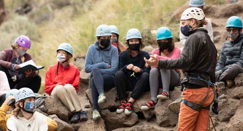 a group of students listen to an instructor on an outward bound course in oregon